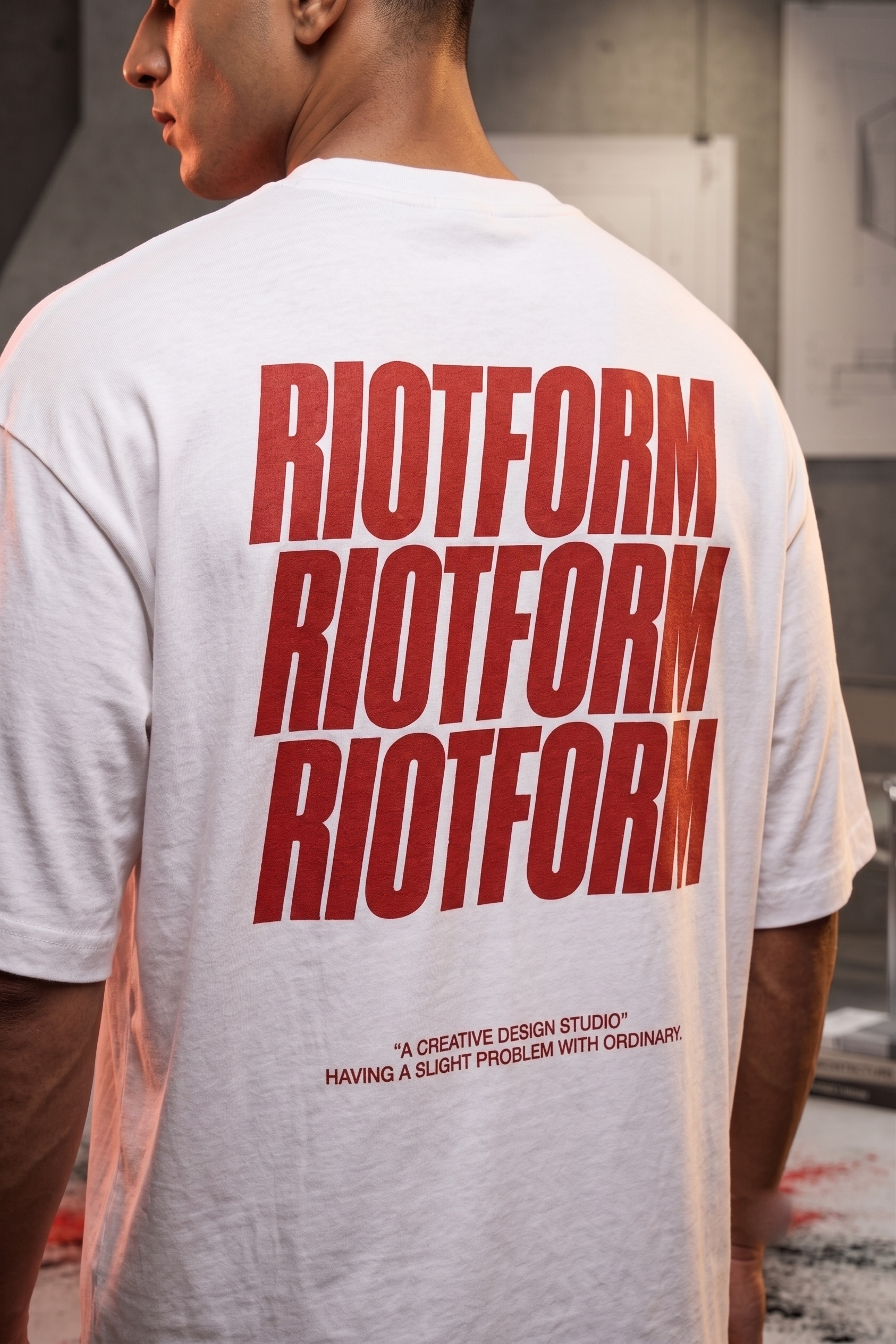 White Mark Terry oversized tee worn, RIOTFORM stacked three times in red across the back